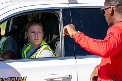 officer instructing a driver during vehicle training