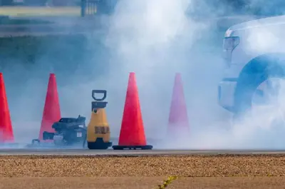 traffic cones around a cloud of smoke at a testing location.