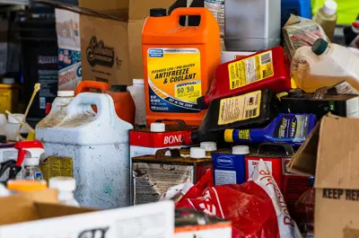collection of bottled hazardous waste products and chemicals piled up.